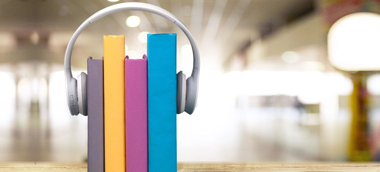 Na imagem vemos uma ilustração de livros usando fones de ouvido
