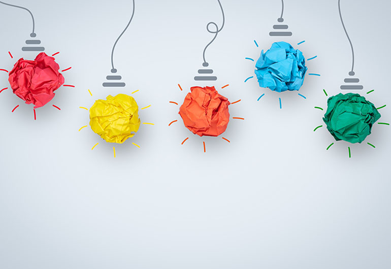 ilustração representa inovação com lâmpadas de papel colorido